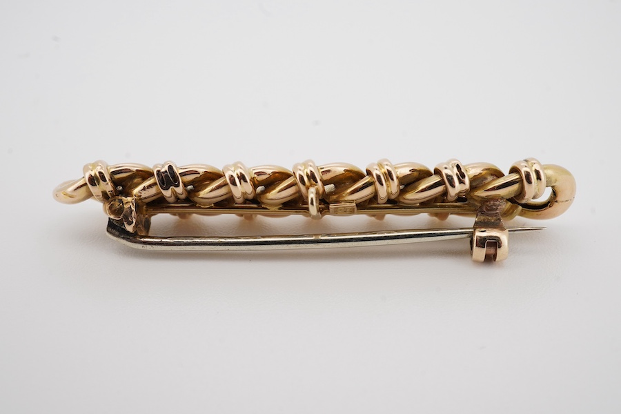 A yellow metal (stamped 15) interwoven link bar brooch, 47mm, gross weight 6.5 grams. Condition - good